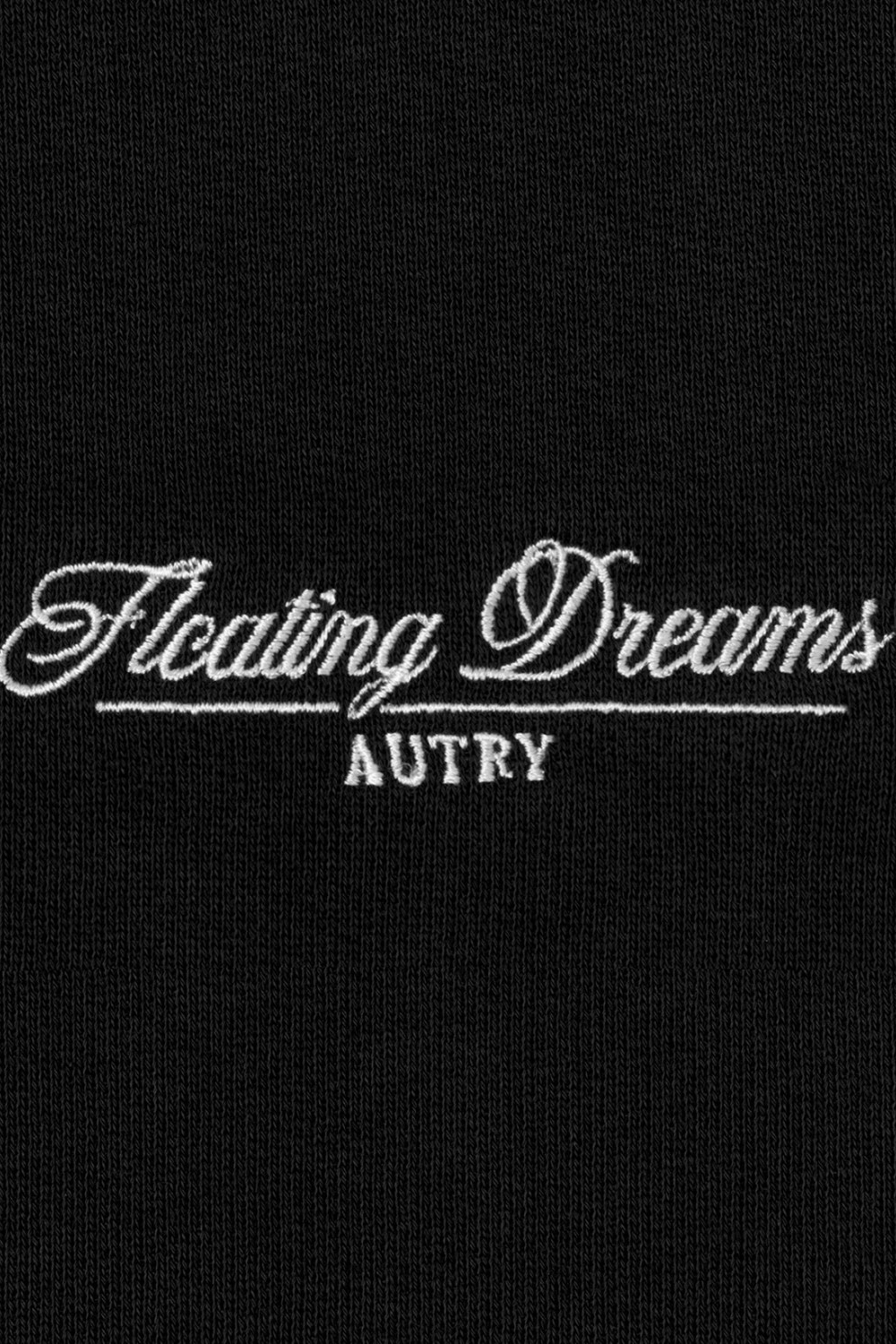 Close up Logo: Schwarzer Hoodie aus ungebürstetem Sweatshirtstoff mit Kapuze, Kordelzug mit Metallösen, gerippten Bündchen und Saum sowie "Floating Dreams" Stickerei auf der Brust in Ton-in-Ton Optik